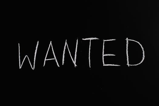 Black chalkboard with 'Wanted' written in white chalk, ideal for hiring or job concept visuals.